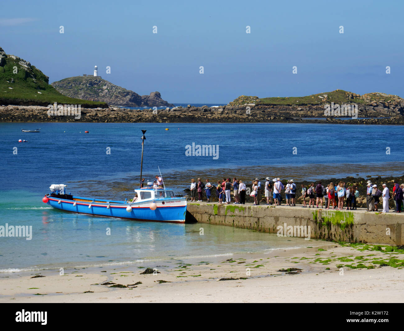 Der Leitstern nimmt Tag Besucher aus Lower Town Quay, St Martin's, Isles of Scilly, mit dem Hintergrund der Insel Tean und Round Island li Stockfoto