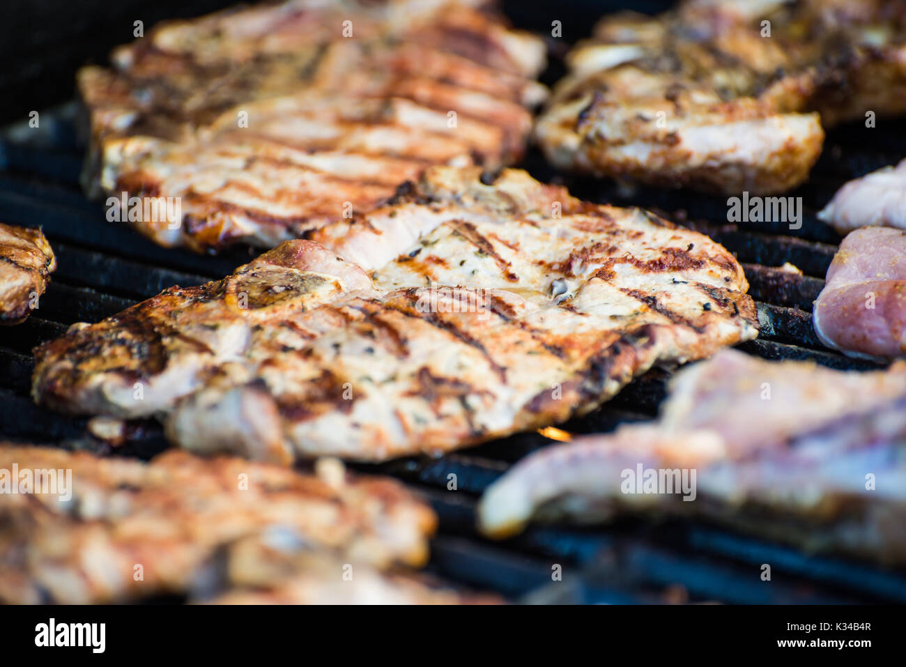 Leckeres Schweinefleisch Steaks mit Gewürzen auf dem Grill Stockfoto