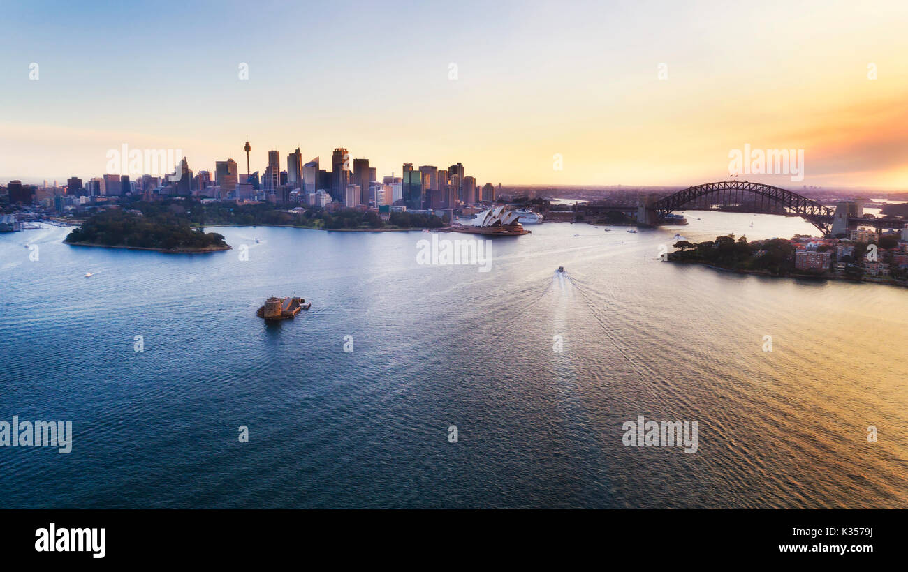 Farbenfroher Sonnenuntergang über die Stadt Sydney CBD und Hafen Wahrzeichen in erhöhten Luftaufnahme über Hafen Wasser. Stockfoto
