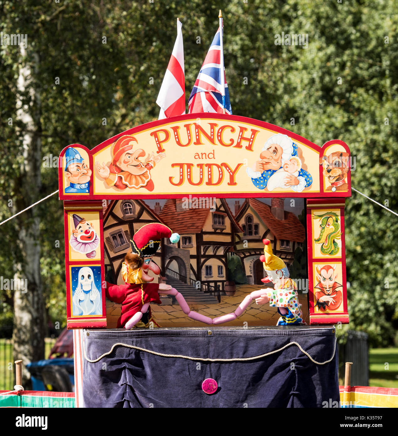 Ein traditionelles Kasperletheater von David Wilde in einem englischen Park im Sommer in Brentwood, Essex mit dem Mr Punch, Clown und Würstchen Stockfoto