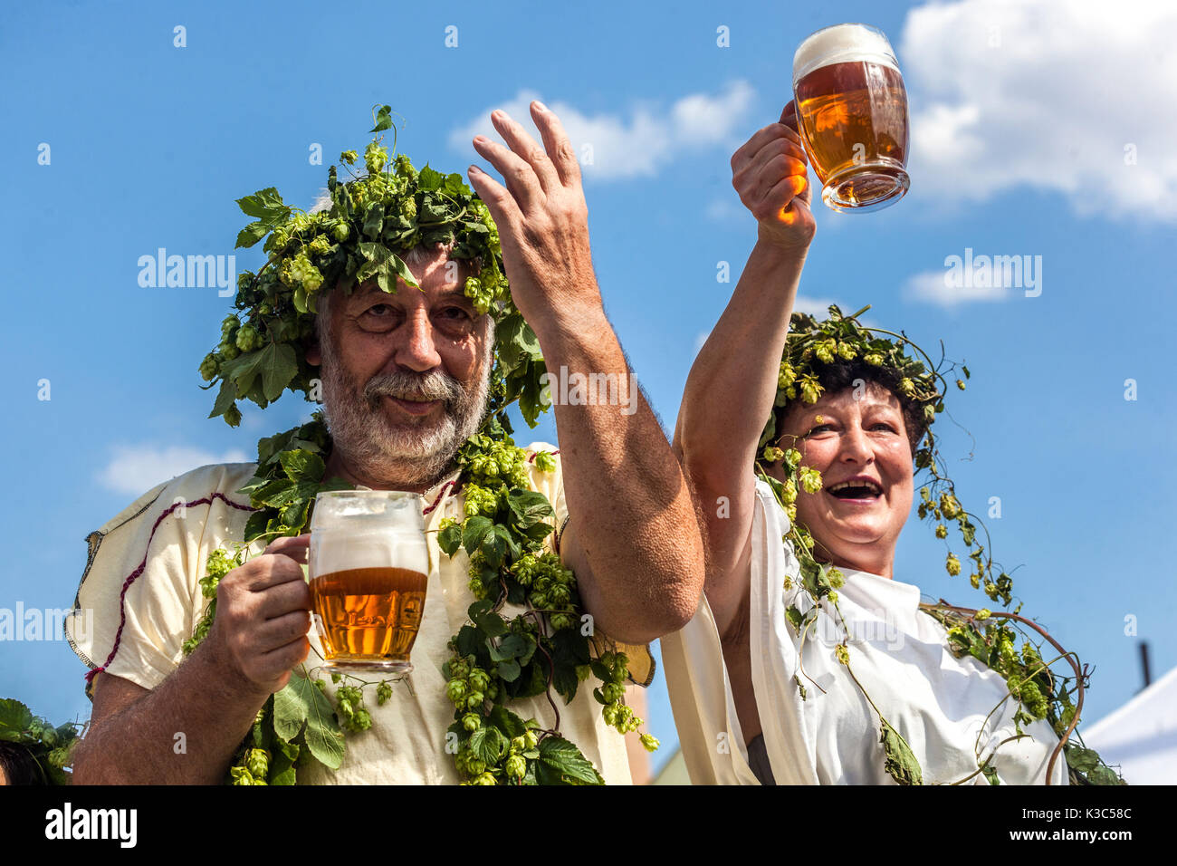 Tschechische Bierfestival Mann Frau Senioren genießt Sommer Menschen feiern dekorierten Hopfenkranz Cheers Rising Hands mit einem Glas Bier Tschechische Republik Stockfoto
