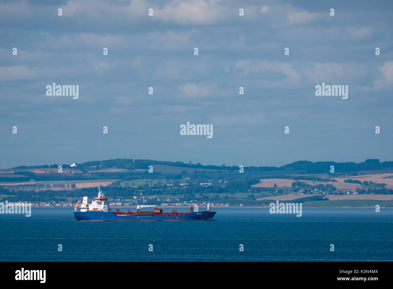 Blick auf das Containerschiff in Firth of Forth, das die Flussmünde entlang der Hügel von Fife, Schottland, Großbritannien, führt Stockfoto