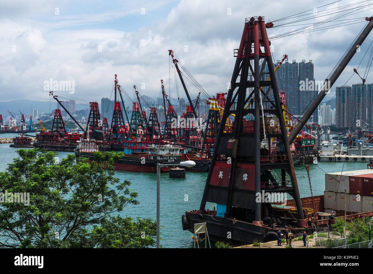 Baggerarbeiten Lastkähne für die Landgewinnung (mit Derrick Krane) in Victoria Harbour und Hong Kong Stockfoto