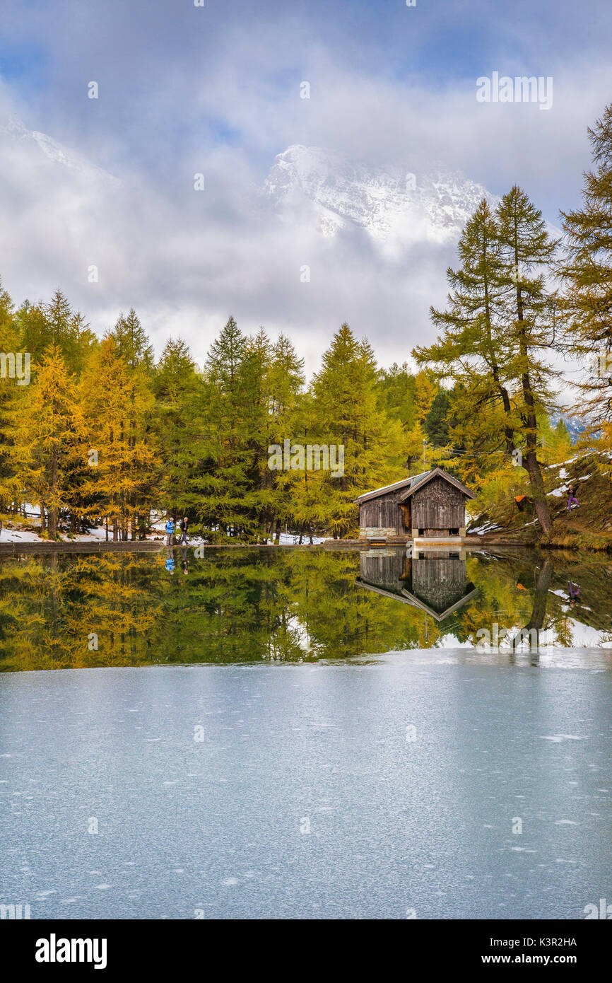 Holzhütte und bunte Bäume spiegeln sich im Lai da Palpuogna Albula Pass Bergün Kanton Graubünden-Engadin-Schweiz-Europa Stockfoto