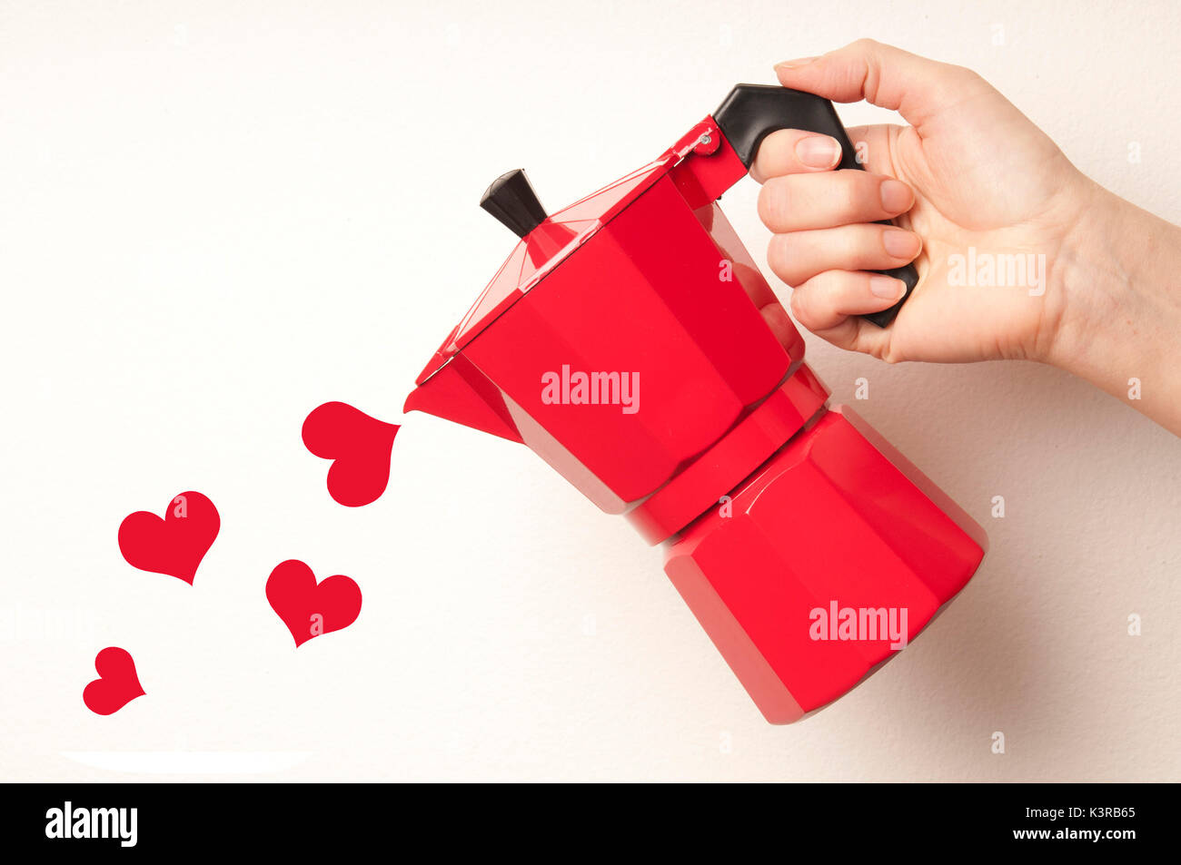 Hand gießen Herzen aus einer Kaffeemaschine moka, Liebe für Kaffee Konzept Stockfoto