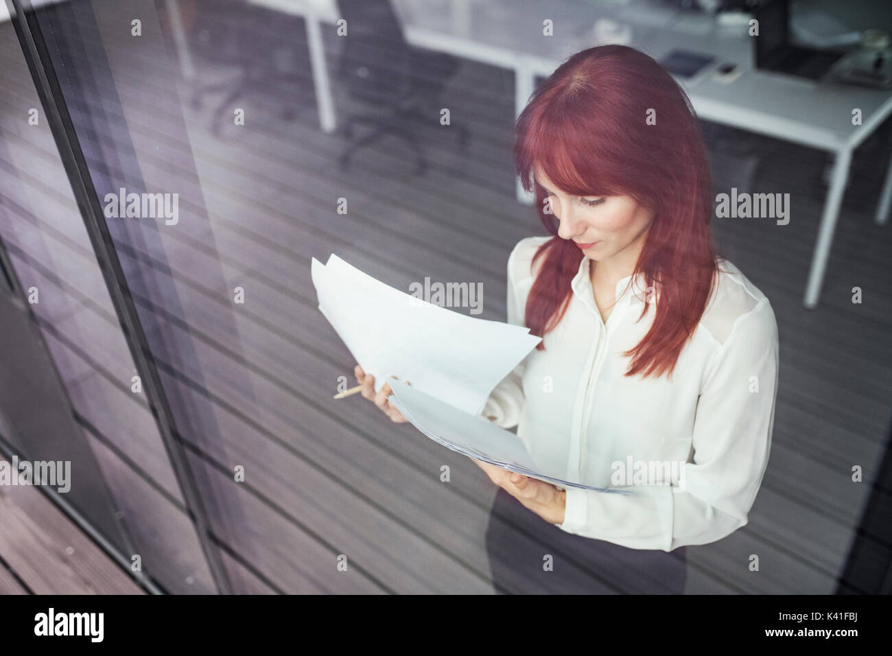 Geschäftsfrau mit Dokumenten in Ihrem Büro arbeiten. Stockfoto