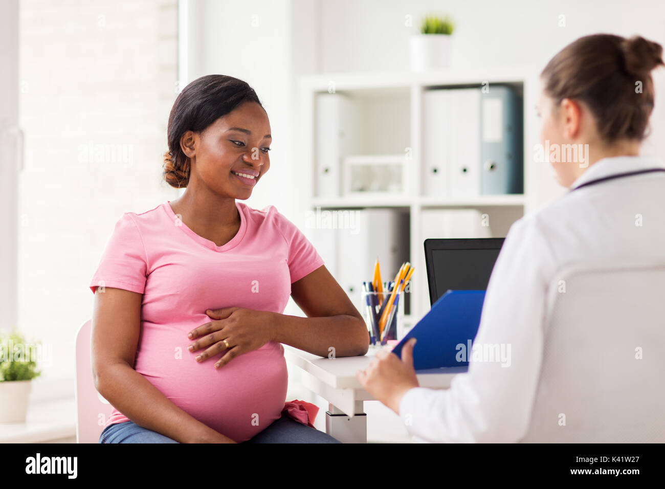 Frauenarzt und schwangere Frau im Krankenhaus Stockfoto