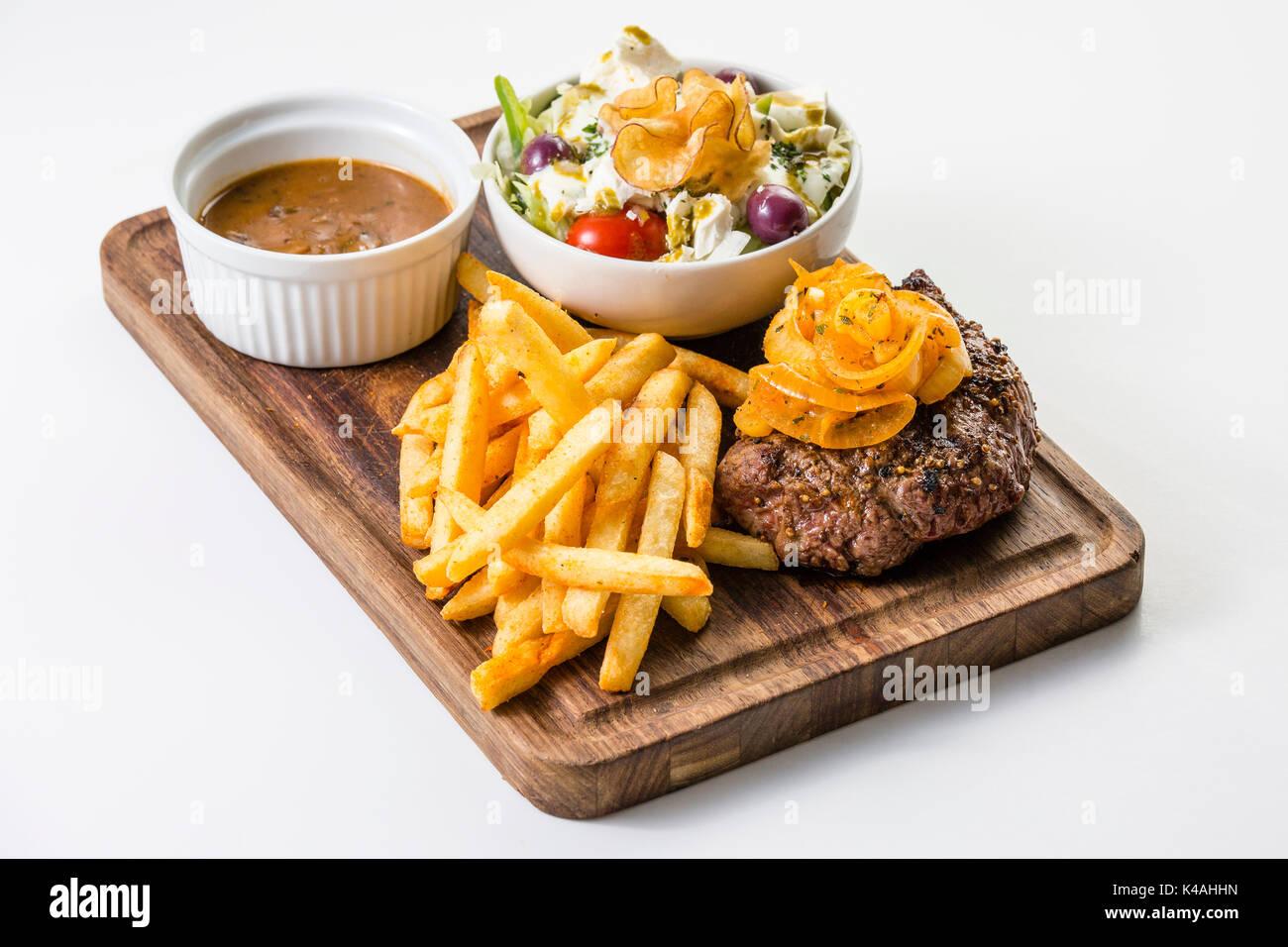 Wild Steak mit geschmorten Zwiebeln, Pommes Frites und einem kleinen Salat Stockfoto