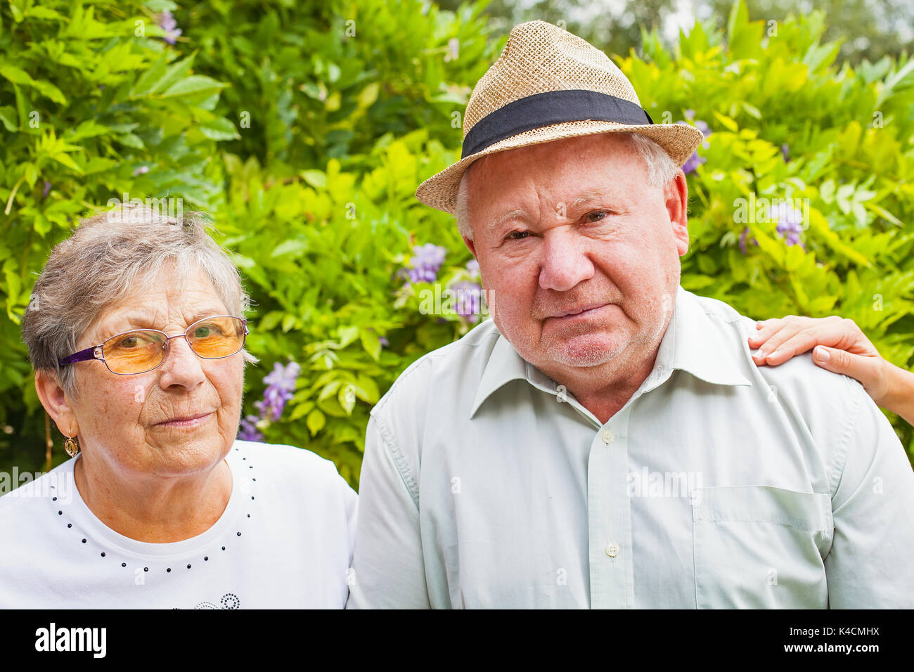 Behinderte senior Paar Hände des Betreuers im Garten outdoor Stockfoto