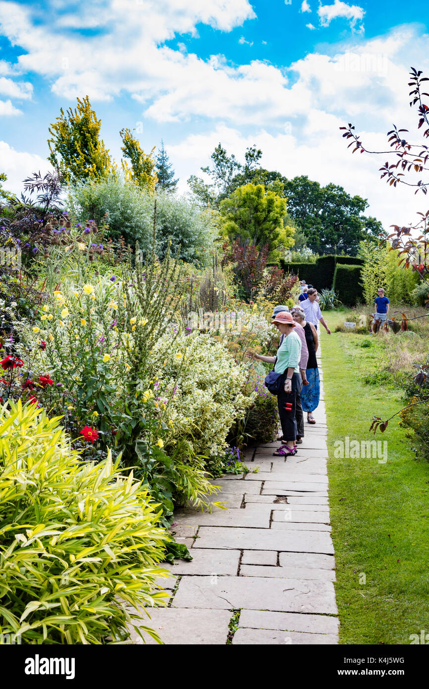 Besucher anschauen und die lange Grenze an der großen dixter Gärten, Ewhurst, East Sussex, Großbritannien diskutieren Stockfoto