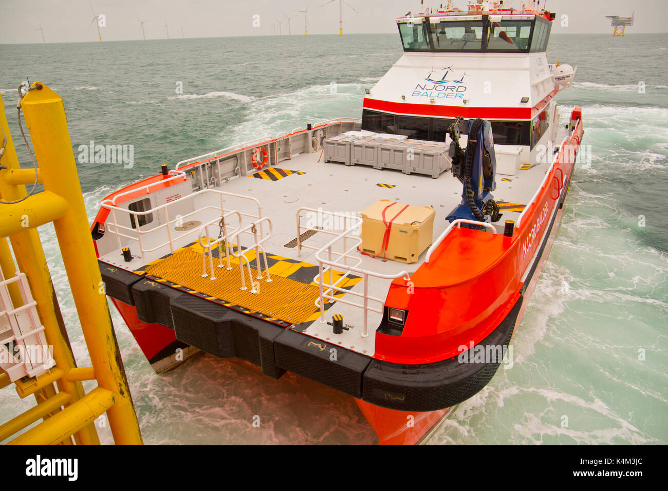 Ein Crew-Transfer-Schiff, das an einem Serviceschiff andockt, das innerhalb eines Offshore-Windparks betrieben wird Stockfoto