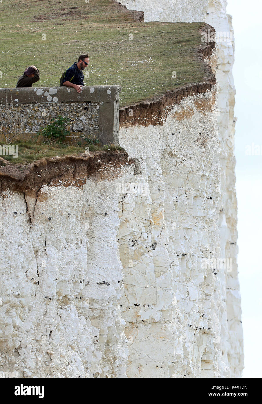 Ein paar stehen am Rand der Klippen am Birling Gap in East Sussex trotz der Sicherheit Warnungen nach den jüngsten Rock im Bereich fällt. Bild Datum: Donnerstag, 7. September 2017. Photo Credit: Gareth Fuller/PA-Kabel Stockfoto