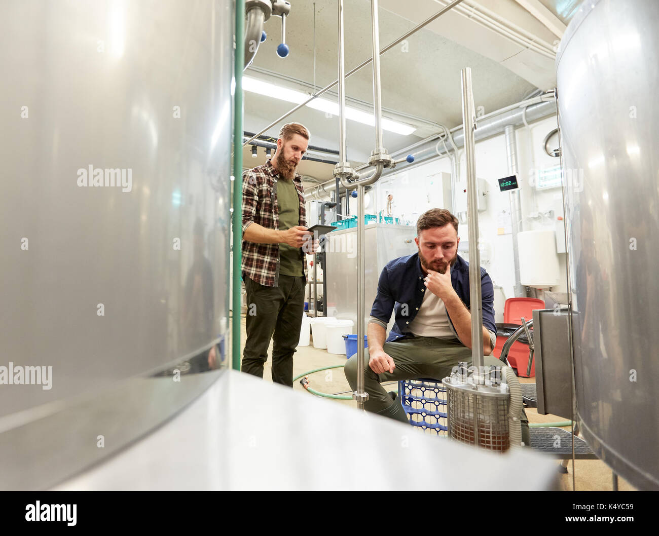Männer mit Tablet-pc im Handwerk Bier Brauerei filter Stockfoto