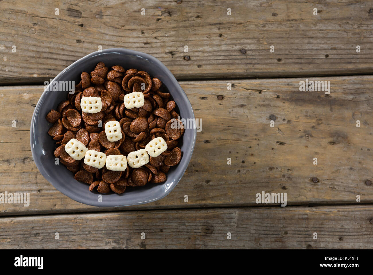 Schokolade Cornflakes mit Honig Müsli schalen Smiley in Schale auf Holztisch Stockfoto