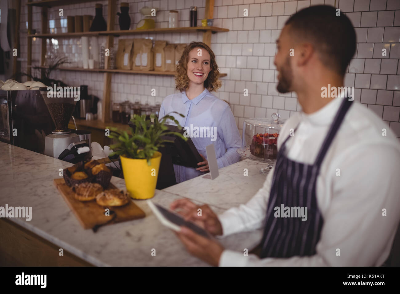 Lächelnden jungen Kellner und Kellnerinnen stehen an der Theke im Café Stockfoto