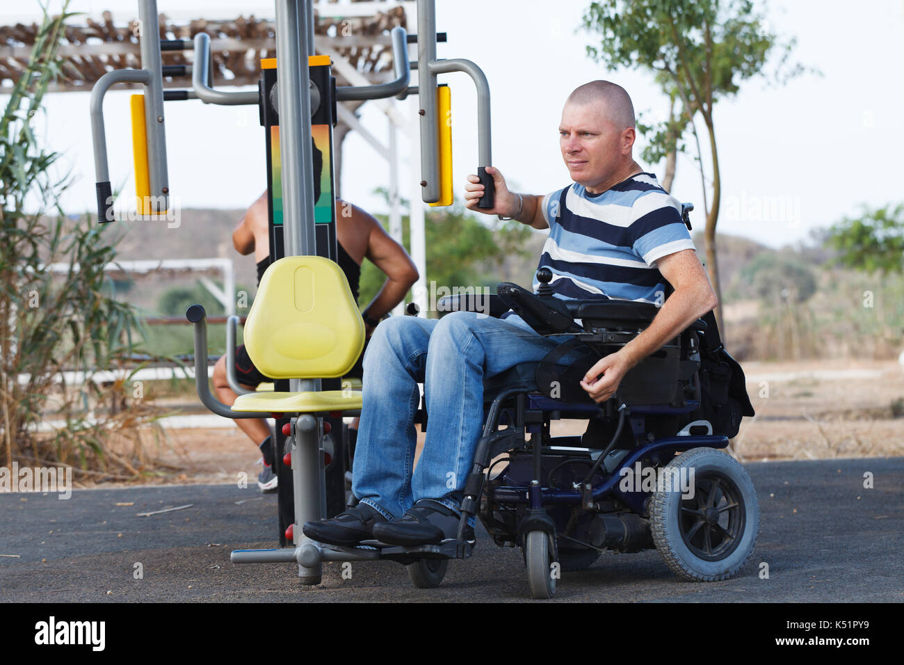 Behinderte Mann im Rollstuhl, mit Trainer. Stockfoto