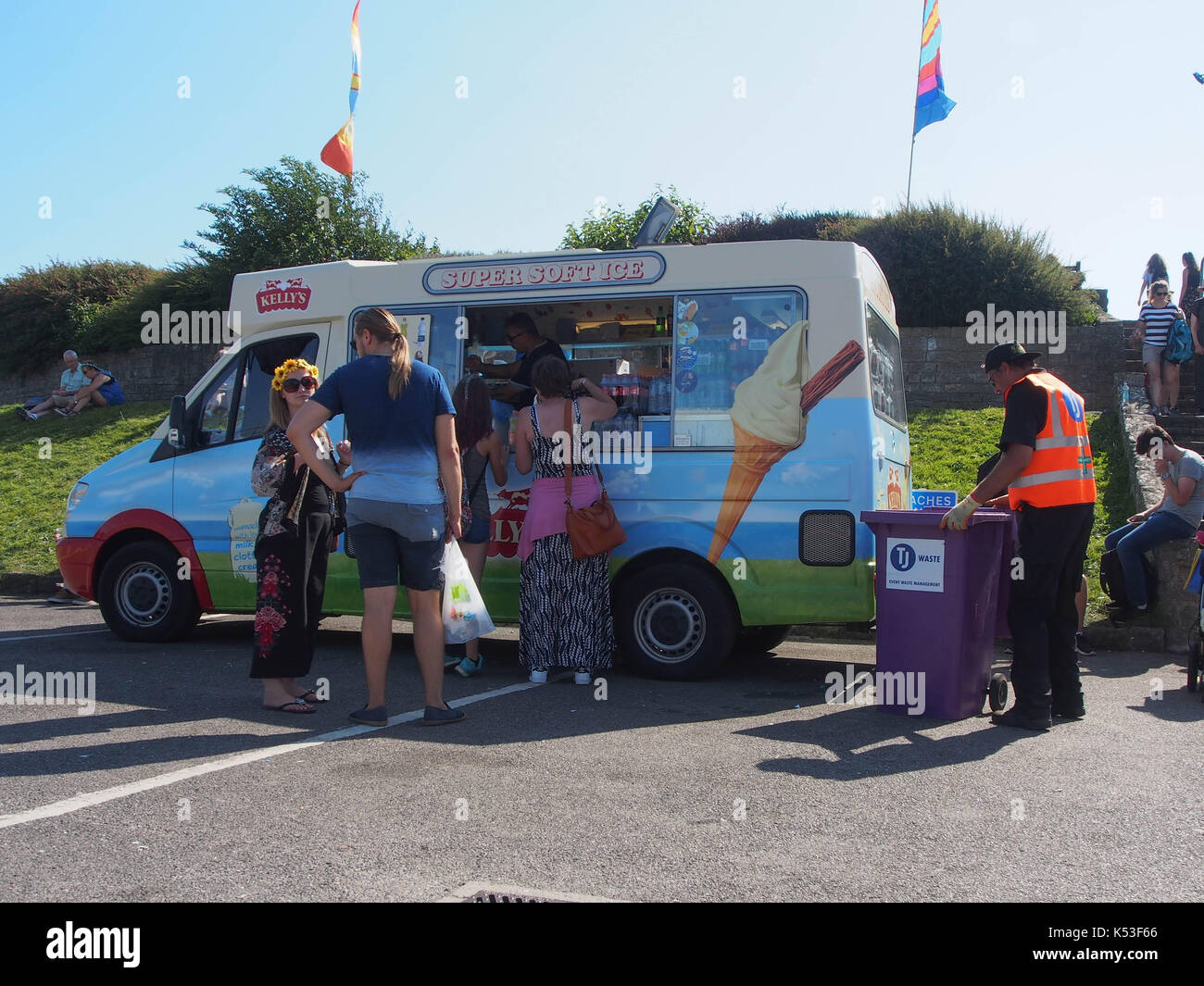 Ein Mann leert Fächer neben Menschen Schlange stehen bei einem Eis Van Stockfoto