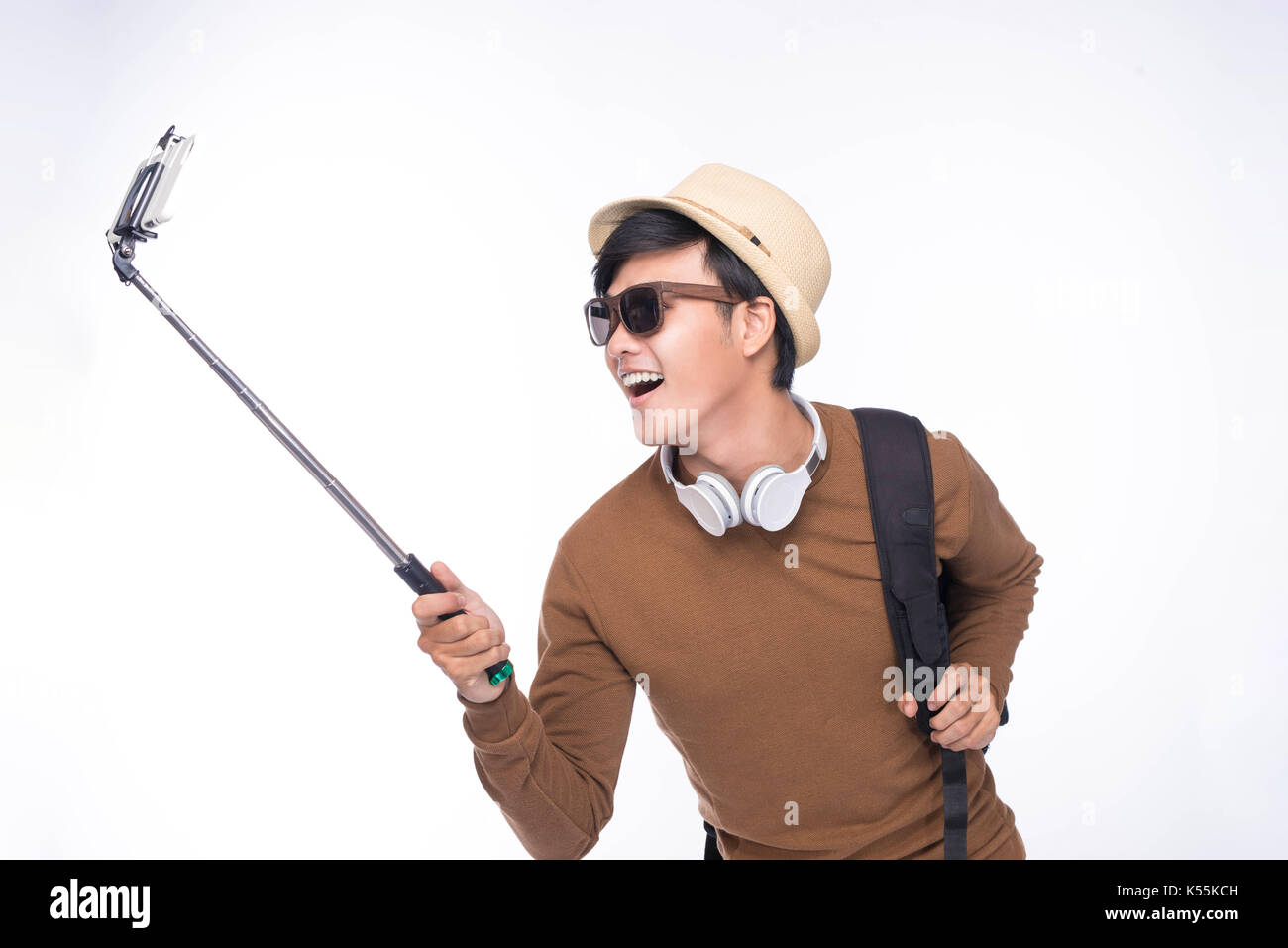 Junge asiatische glücklich unter Selbstporträt Fotografie durch smart-phone Stockfoto