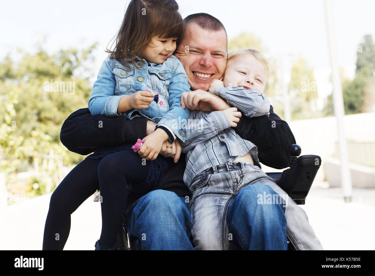 Behinderten Vater spielen mit seinem kleinen Sohn und Tochter Stockfoto
