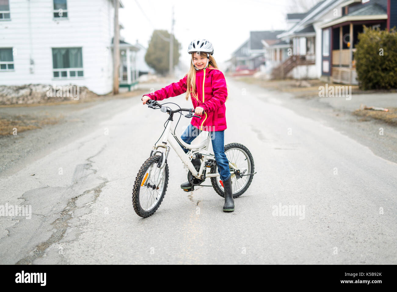 Ein kleines Mädchen mit dem Fahrrad in einer Stadt Stockfoto