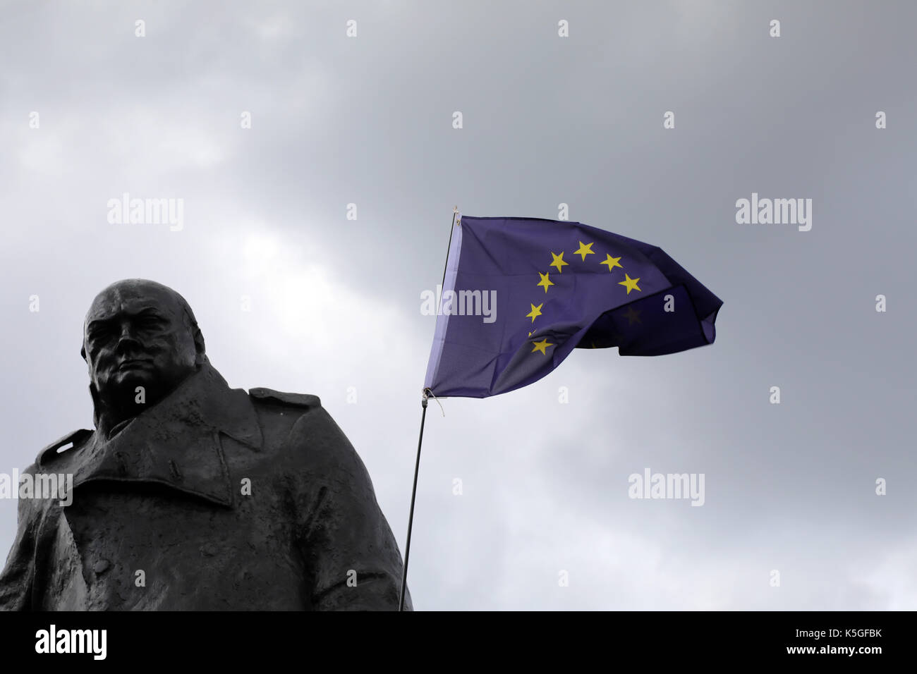London, Großbritannien. 9. September 2017. Eine EU-Flagge gehalten, gegen eine Statue des ehemaligen britischen Premierminister Winston Churchill, im Parlament Square Garden, Central London, während der März für Europa, ein Anti-Brexit Rallye, am 9. September 2017 Quelle: Dominic Dudley/Alamy leben Nachrichten Stockfoto