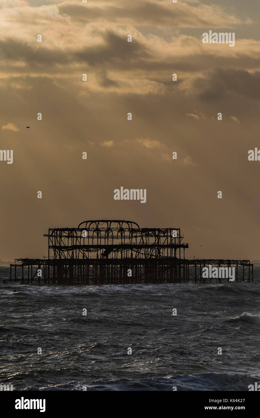 Brighton, UK. 11 Sep, 2017. UK Wetter. Die Sonne bricht durch die Wolken über die Reste der alten Pier - Dämmerung auf einem blustery Abend am Strand von Brighton. Credit: Guy Bell/Alamy leben Nachrichten Stockfoto