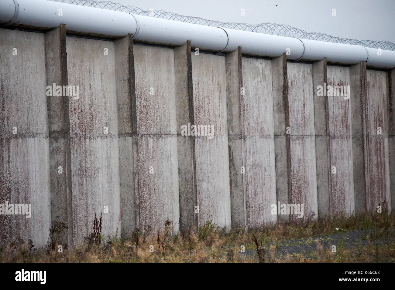Stacheldraht gekrönt Innenwände eines der H-Blöcke in der ehemaligen Labyrinth Gefängnis Long Kesh website Nordirland Stockfoto