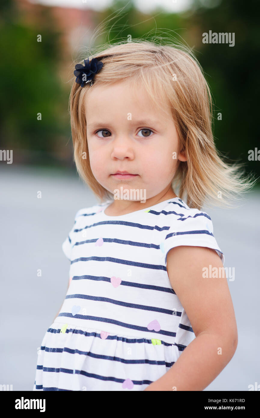 Portrat Eines Zwei Jahre Alten Madchen In Einem Gestreiften Kleid Schones Gesicht Kurze Blonde Haare Ernsten Blick Stockfotografie Alamy