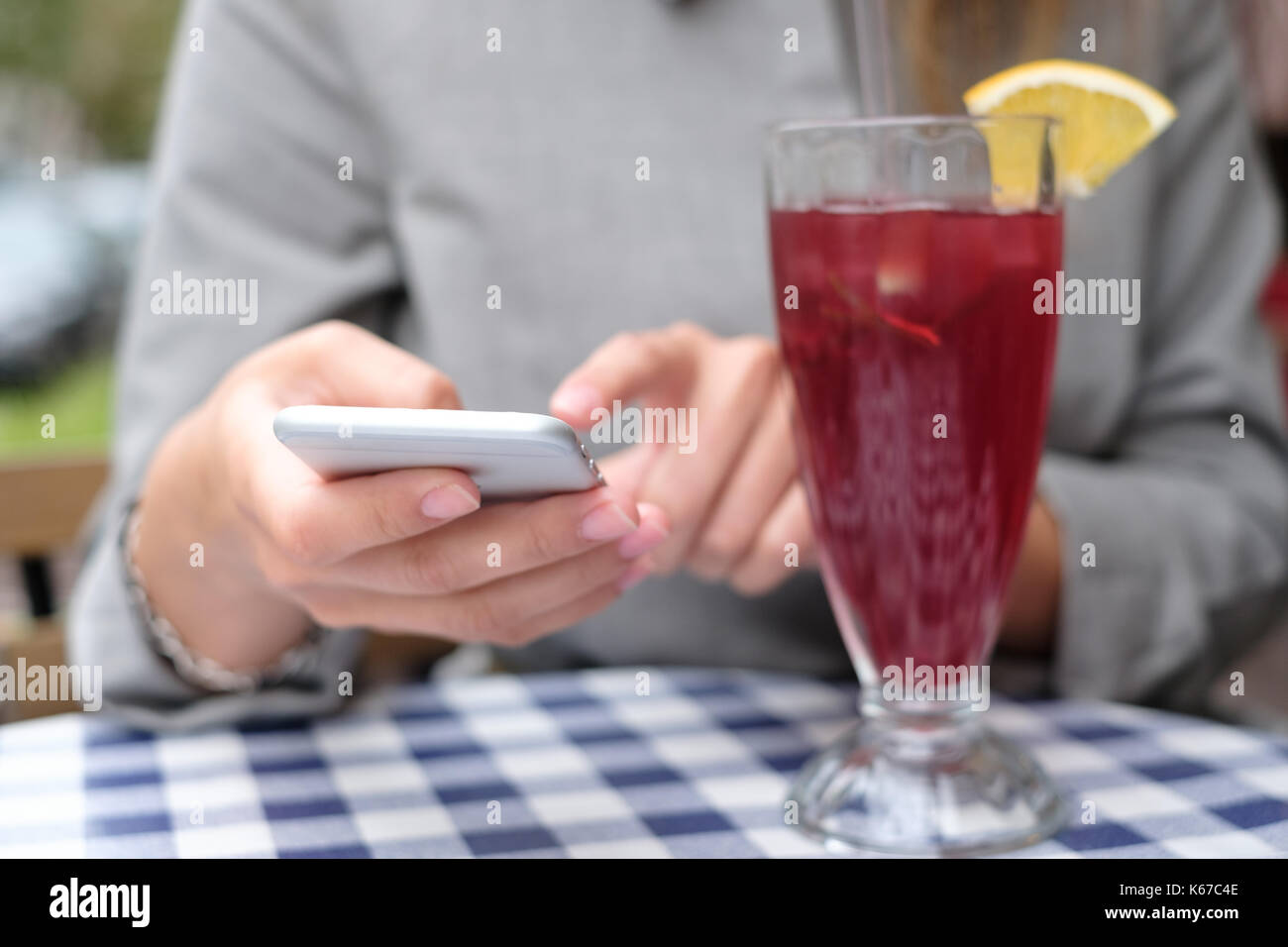 Frau, die in einem Cafe über Ihr Mobiltelefon Stockfoto