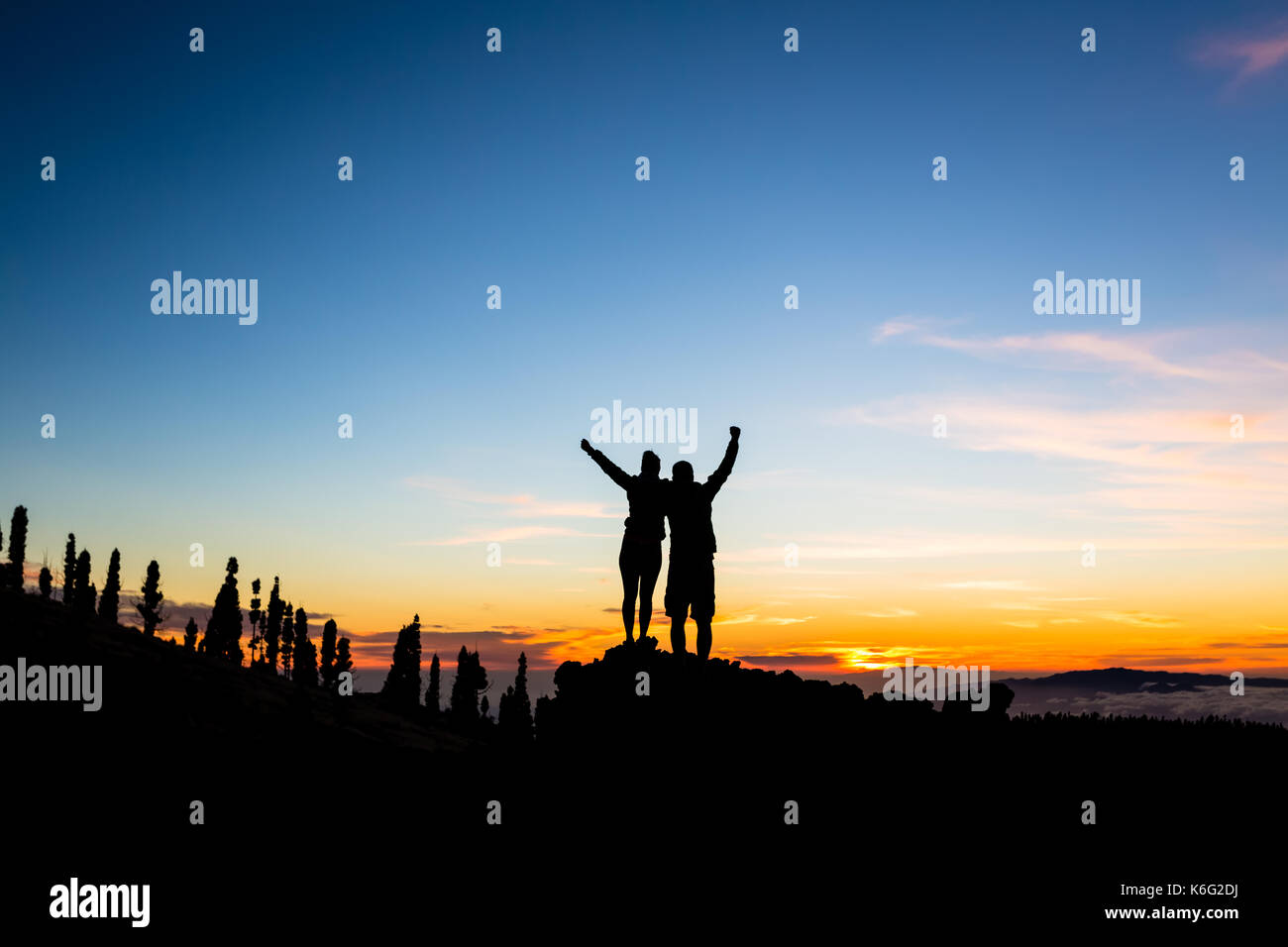 Teamwork Paar klettern und Berggipfel. Silhouette von feiern Kletterer Team über Berge Sonnenuntergang. Mann und Frau Wanderer suchen in Stockfoto