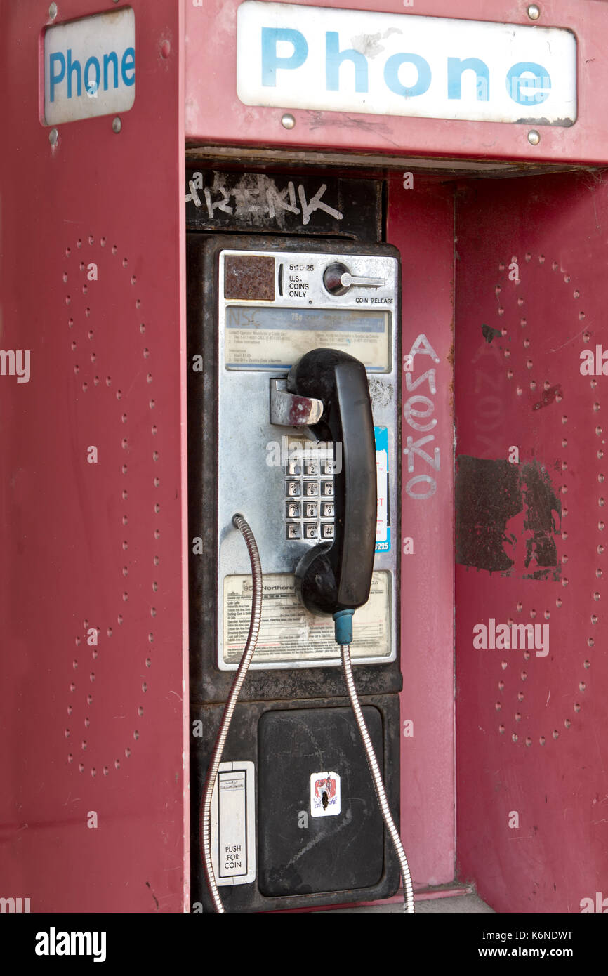Verlassen" Antiken "münzautomaten öffentliches Telefon mit Münze release Steckplatz, Graffiti, alten Shopping Center, Kalifornien, USA. Stockfoto