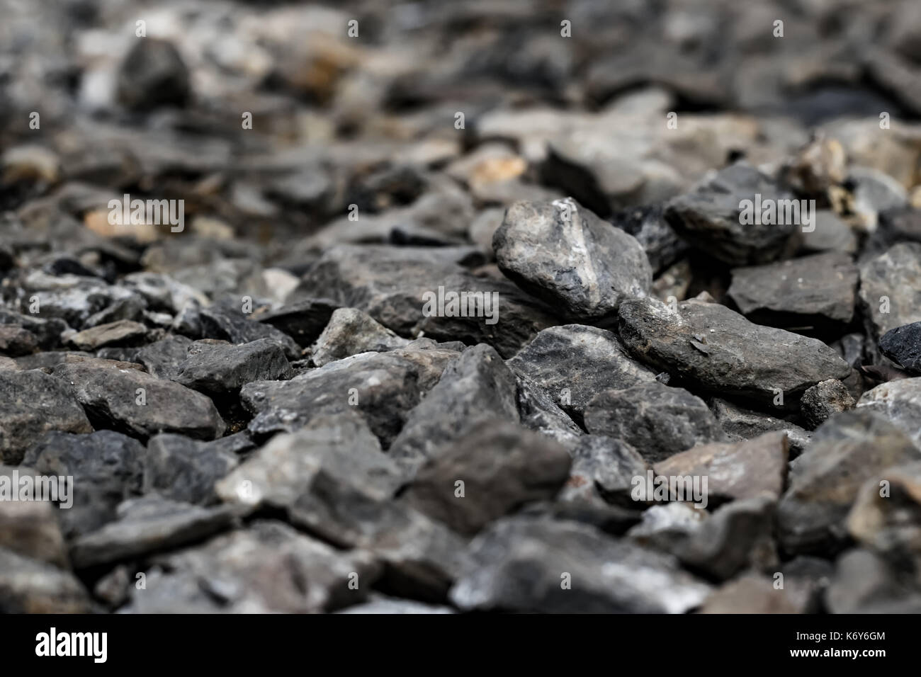 Kleine schwarze Felsen oder Steine auf den Boden wie Holzkohle mit Nähe zu sehen, die Beschaffenheit der Oberfläche Rock für den Hintergrund und die Textur zu zeigen. Stockfoto