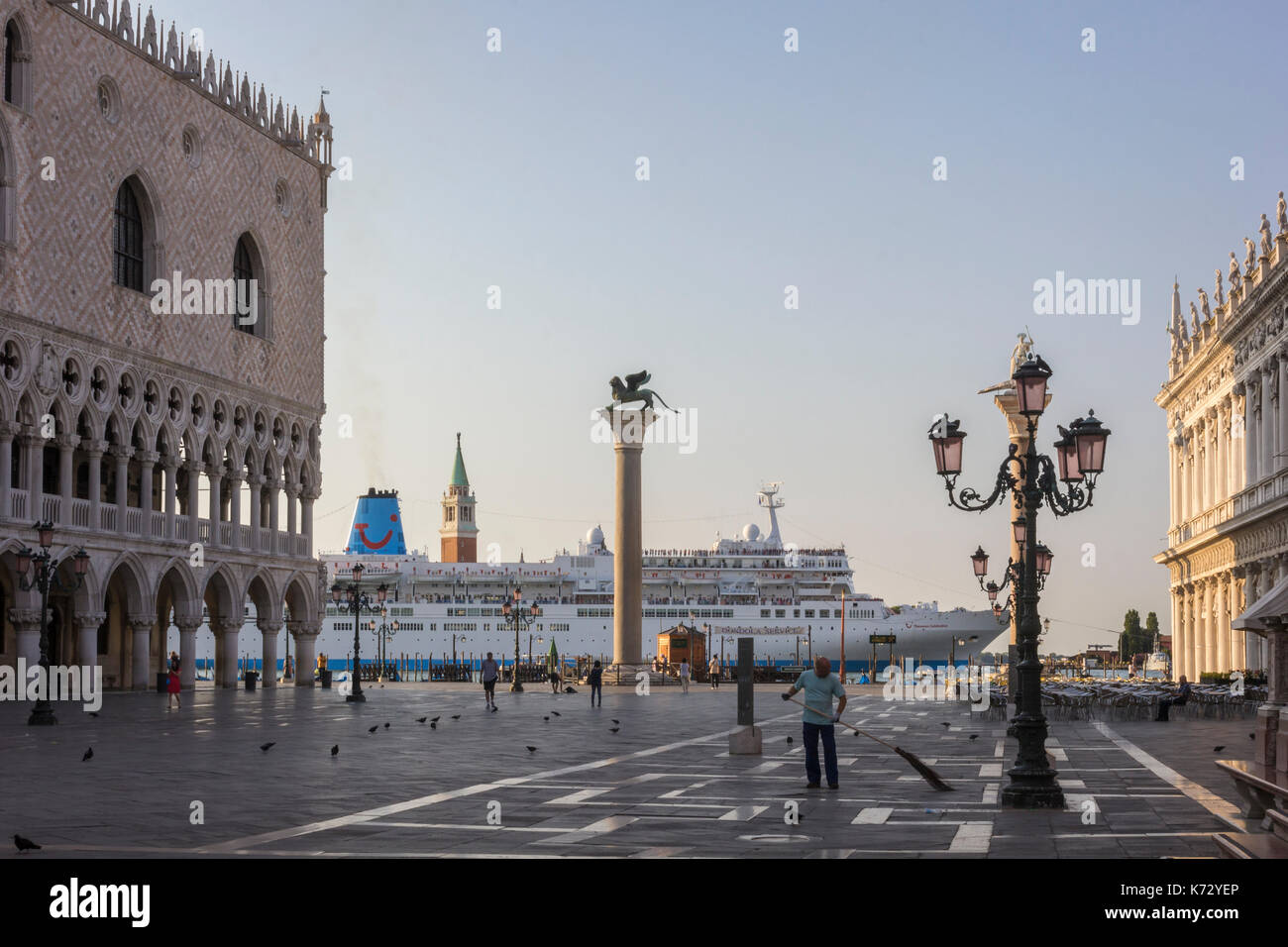 Ein Kreuzfahrtschiff ist vorbei an der Piazza San Marco in Venedig, Italien, am frühen Morgen im Sommer. Auf der linken Seite ist der Dogenpalast. Stockfoto