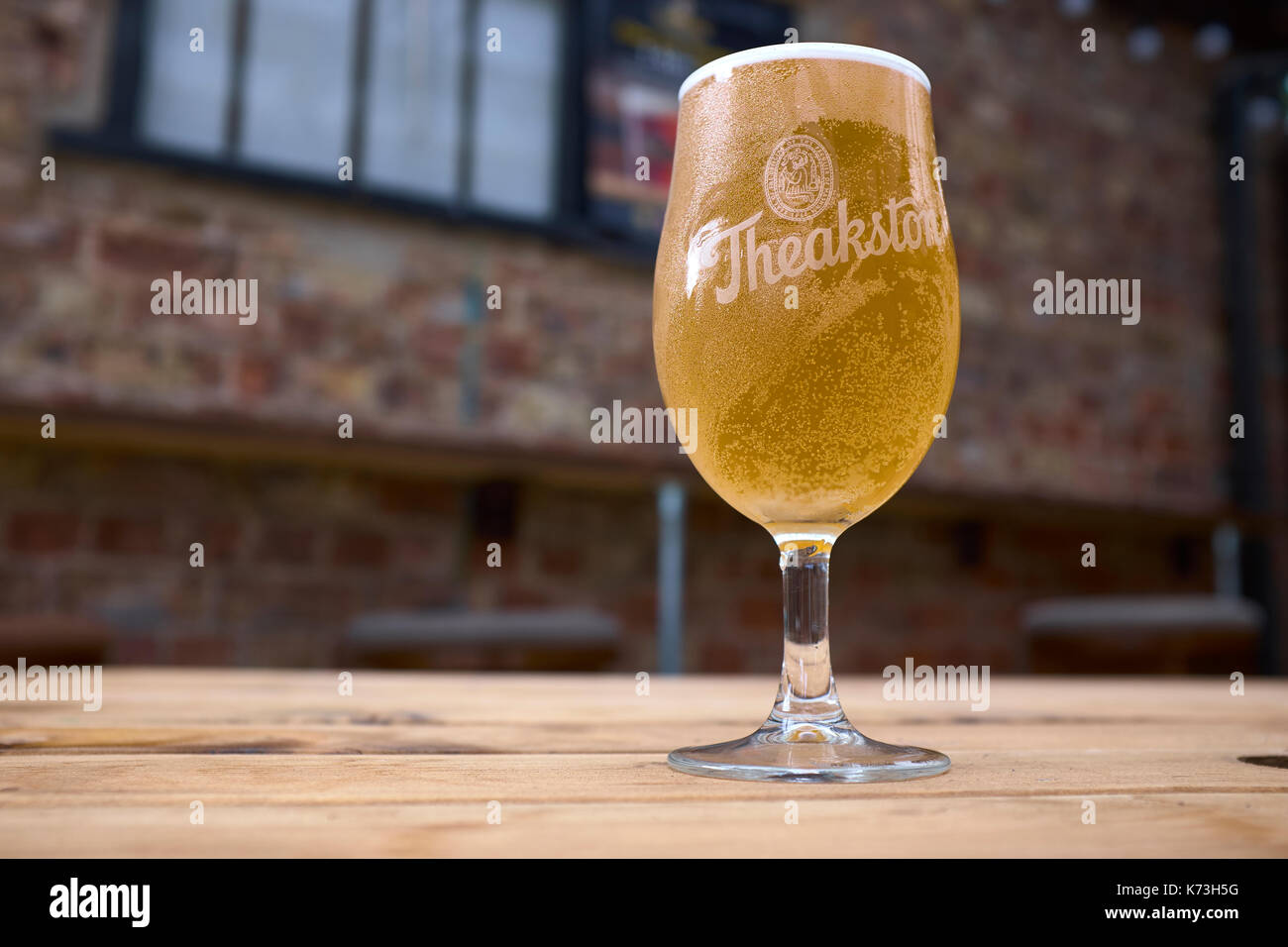 Halben pint Theakston's Ale in einer stammte aus Glas auf einem Holztisch, Yorkshire, Vereinigtes Königreich Stockfoto