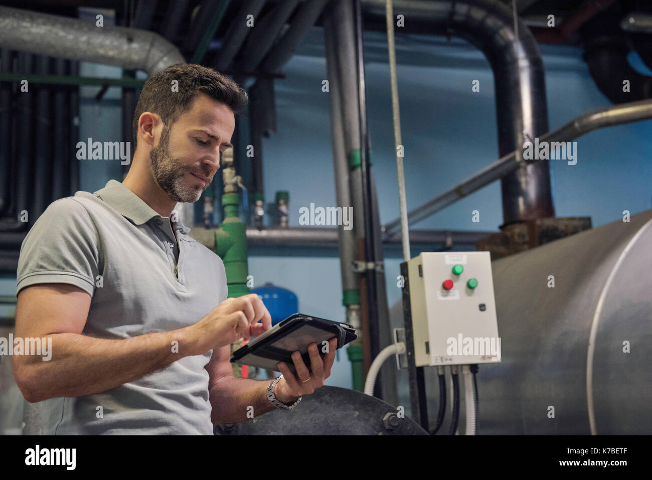 Mann mit digitalen Tablette im industriellen Umfeld Stockfoto