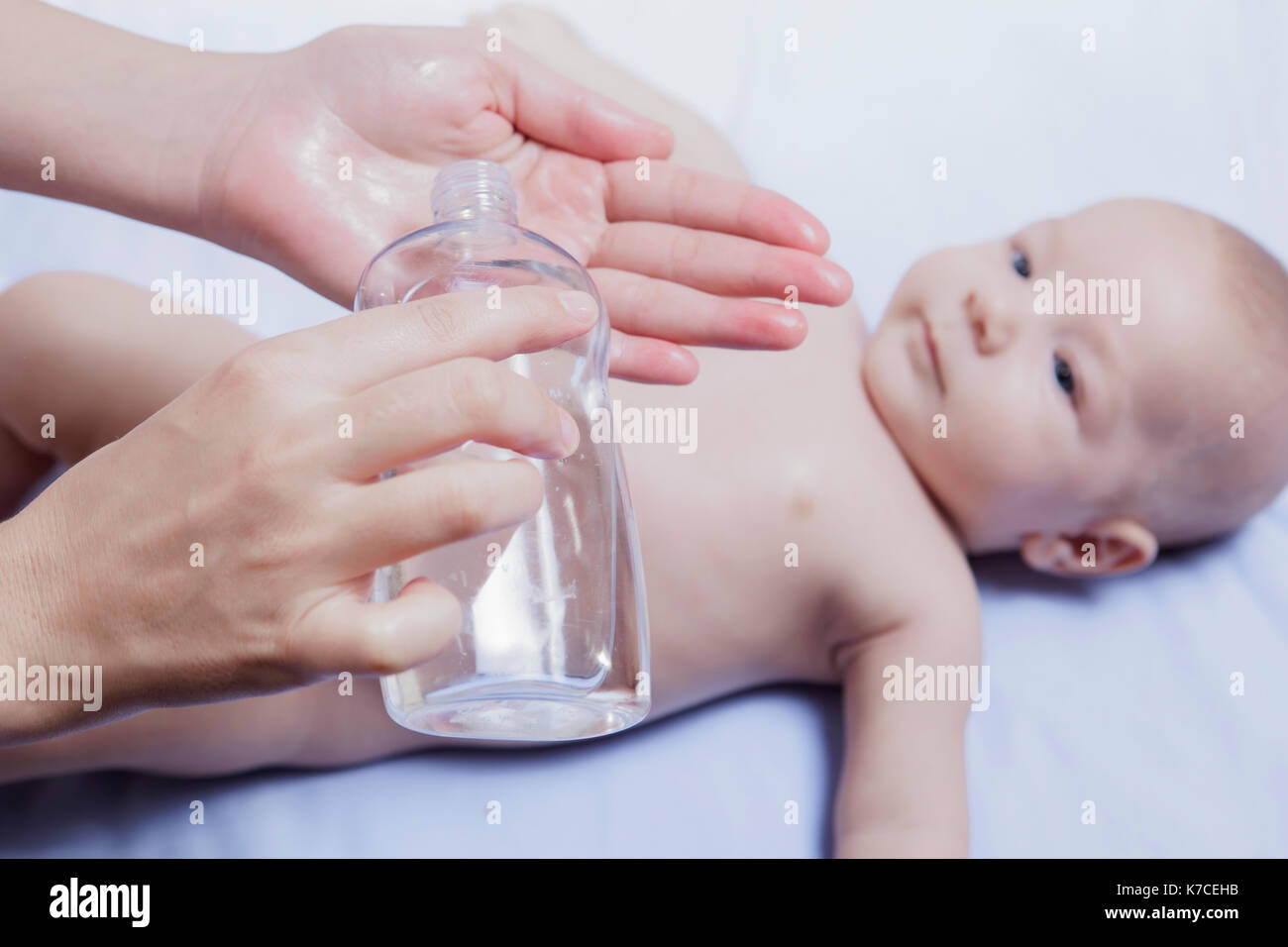Vor kurzem gereinigt Baby bereit für Öl. Mutter mit Flasche in der hand Stockfoto