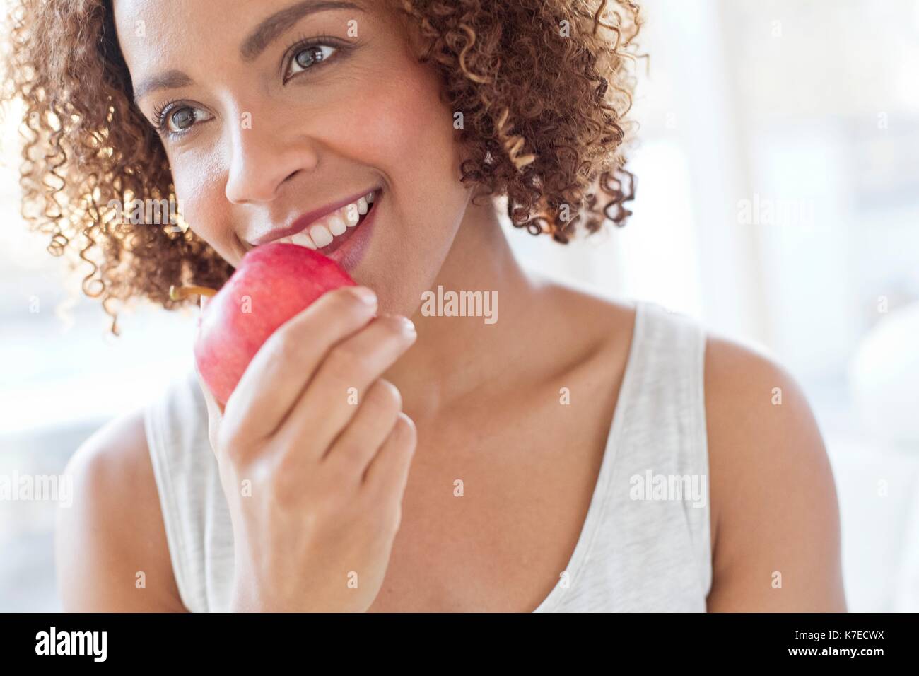 Mitte der erwachsenen Frau essen Apple. Stockfoto