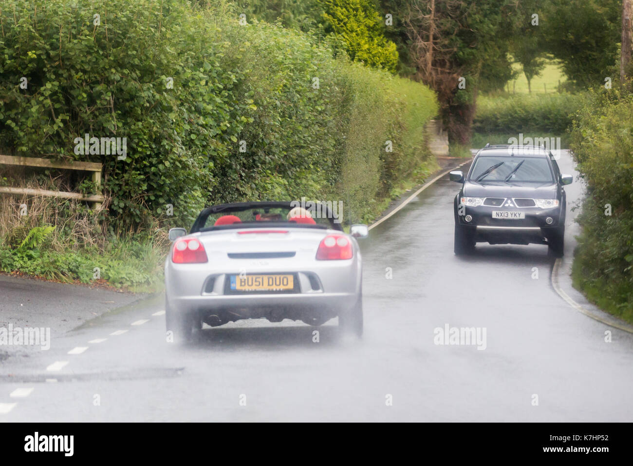 Ein Autofahrer fahren seines offenen (Cabrio) Auto in den Regen entlang der B4340 in Wales Stockfoto