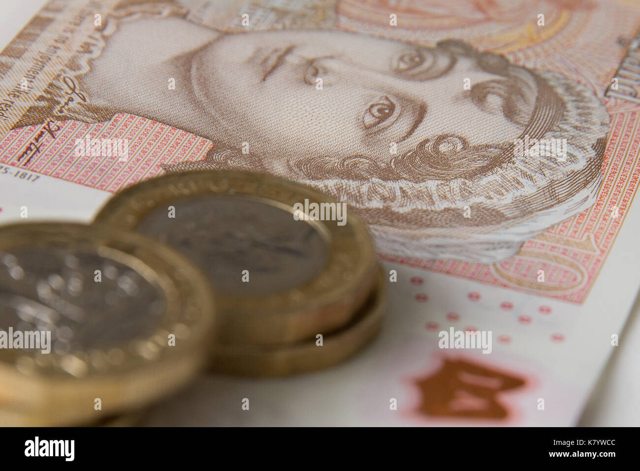 Bild des Neuen, Kunststoff, zehn Pfund Sterling, mit fünf Pfund Sterling Münzen auf seine Spitze. Stockfoto