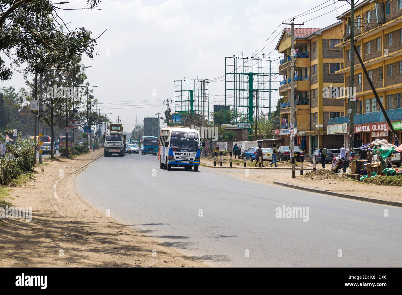 Fahrzeuge fahren auf Jogoo Straße mit Menschen und Gebäude im Hintergrund, Nairobi, Kenia Stockfoto