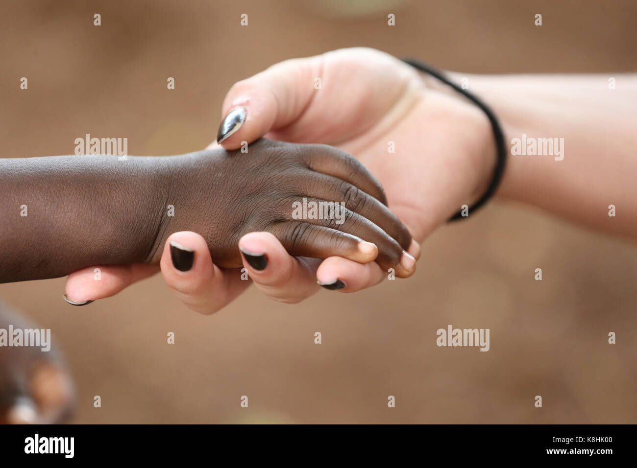 Die Hand des Humanitären Arbeiter holding Kind. Togo. Stockfoto
