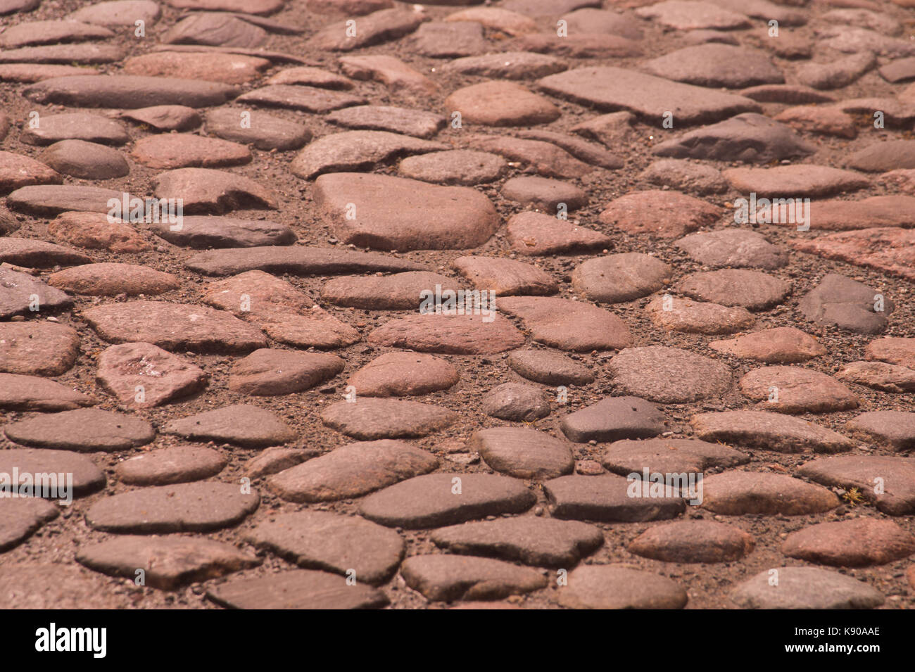 Stein Straße mit Kopfsteinpflaster Textur Hintergrund Stockfoto