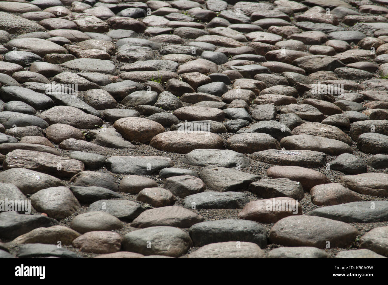 Stein Straße mit Kopfsteinpflaster Textur Hintergrund Stockfoto