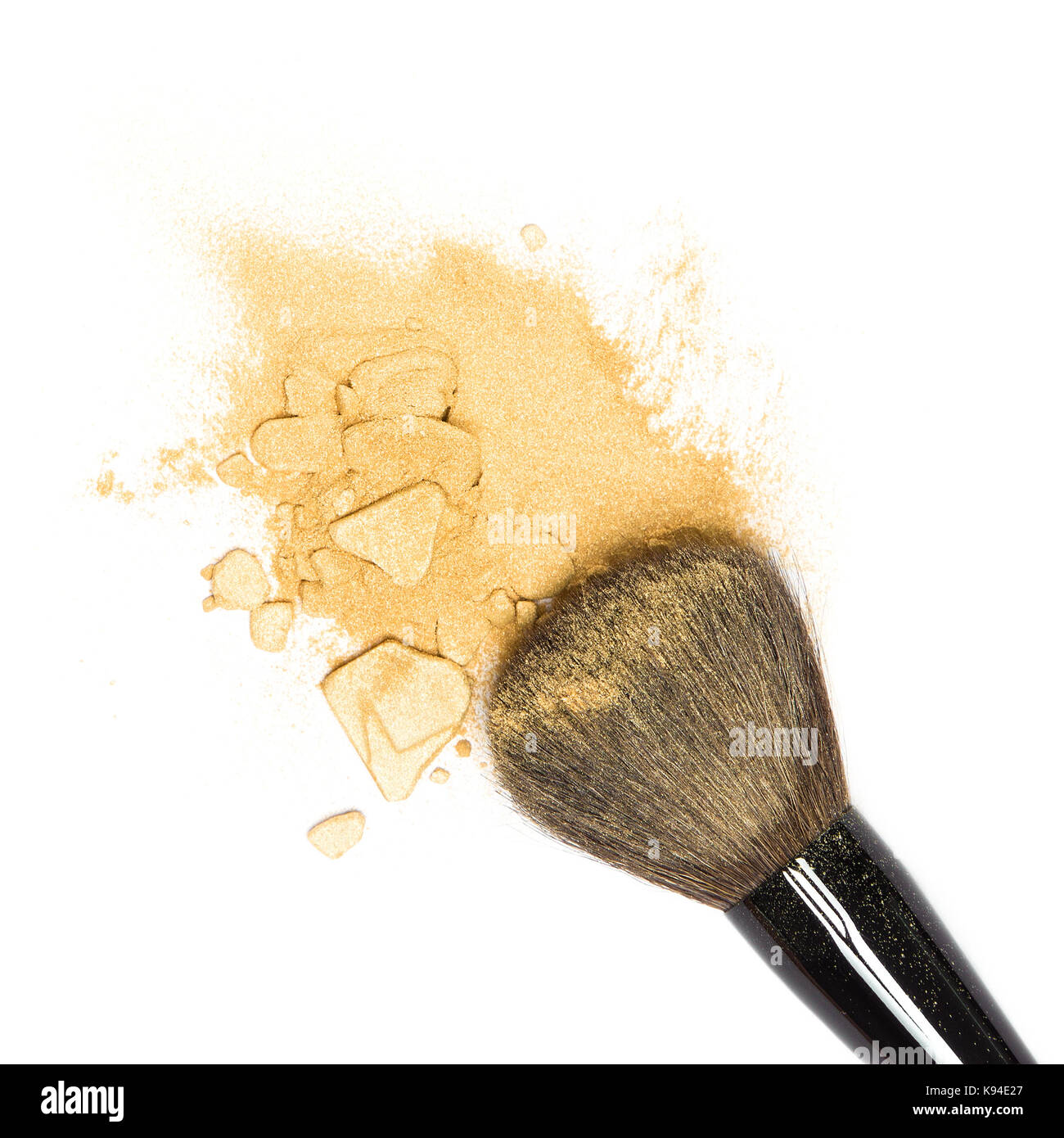 Close-up crushed Mineral shimmer Powder goldene Farbe mit Make-up-Pinsel auf weißem Hintergrund Stockfoto