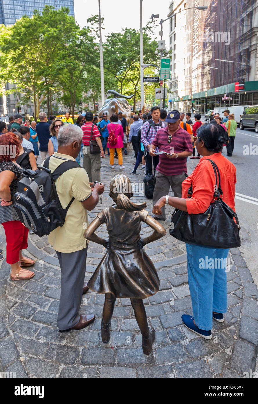 Die wütenden Stier Statue und der furchtlose Mädchen Statue von Touristen im Finanzdistrikt umgeben, in der Nähe der New Yorker Börse in Manhattan, Stockfoto