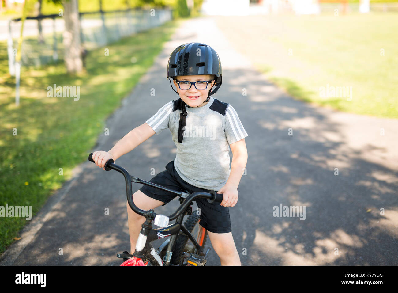 Sechs Jahre alten Jungen Radfahren im Park Stockfoto