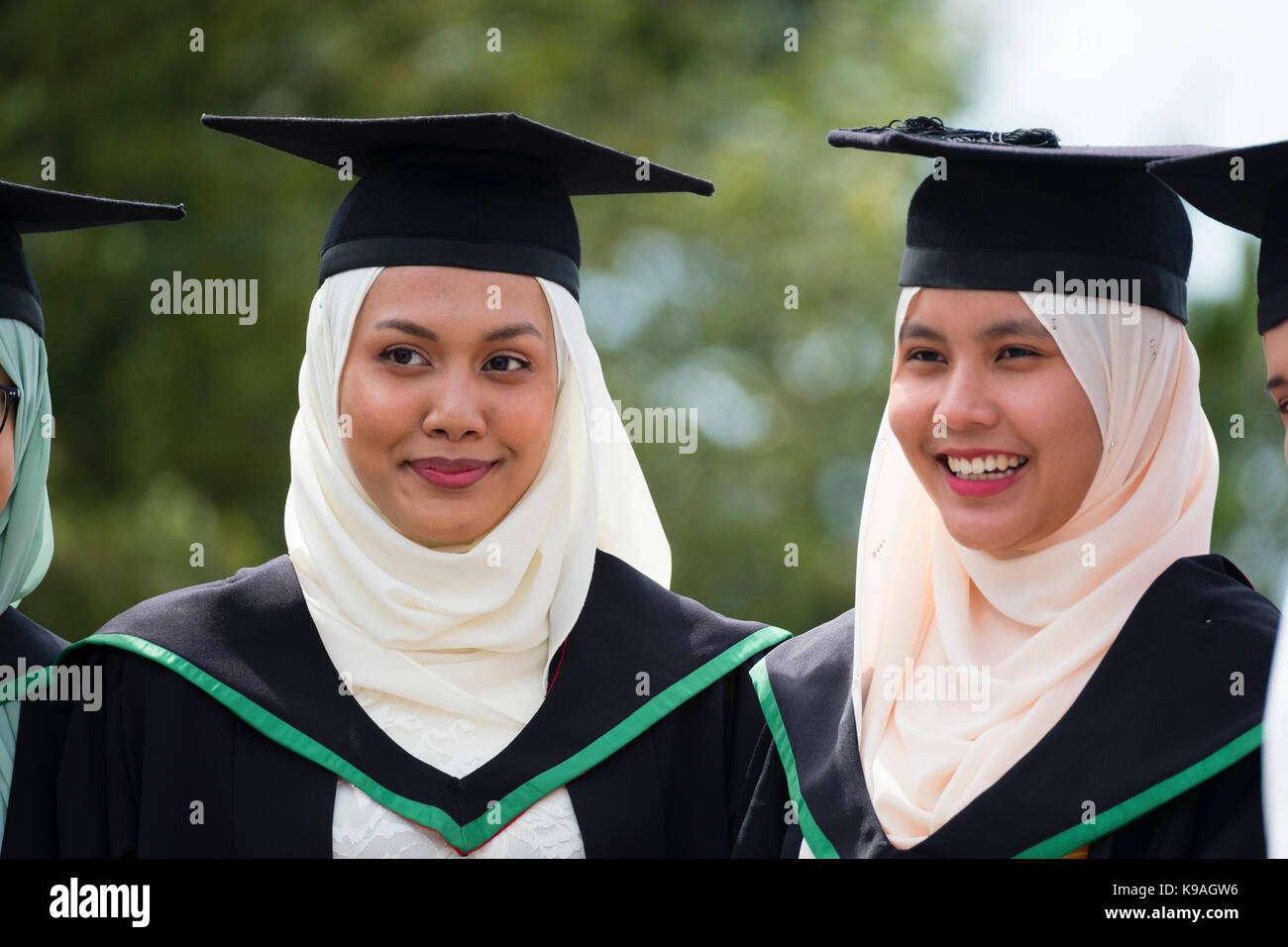 Höhere Bildung in Großbritannien: Eine Gruppe von ausländischen überseeischen Asiatischen Aberystwyth Studenten tragen traditionelle akademische Kittel und Mörtel Platten auf ihre Graduation Day, Juli 2017 Stockfoto