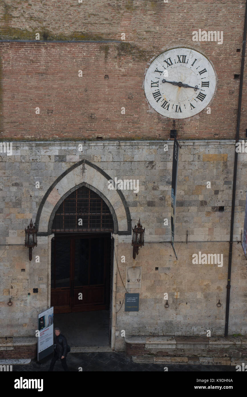 Italien, Siena - 26. Dezember 2016: der Blick auf Santa Maria della Scala Eingang und antike Uhr 1643 AD mit nur Stunden hand am 26. Dezember 2016 in der Si Stockfoto