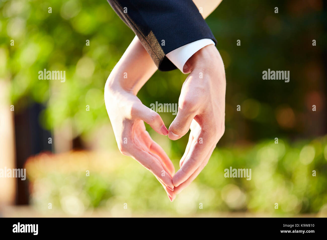 Nahaufnahme der Hand eines liebenden Paares, die Form eines Herzens. Stockfoto