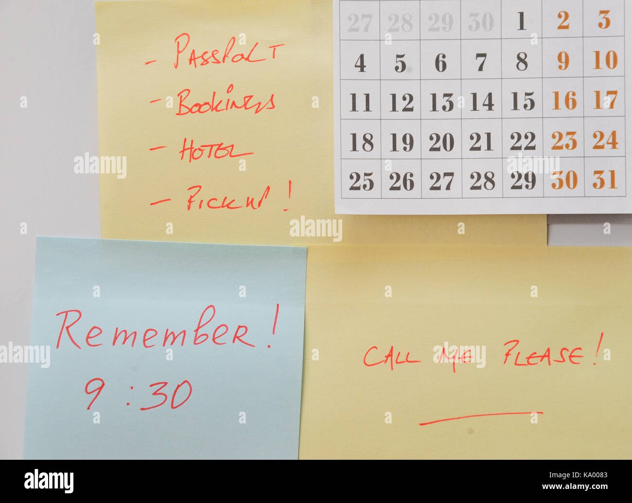 Post-it-Notizen und Kalender auf Kühlschrank mit Erinnerungen an Reisen Stockfoto